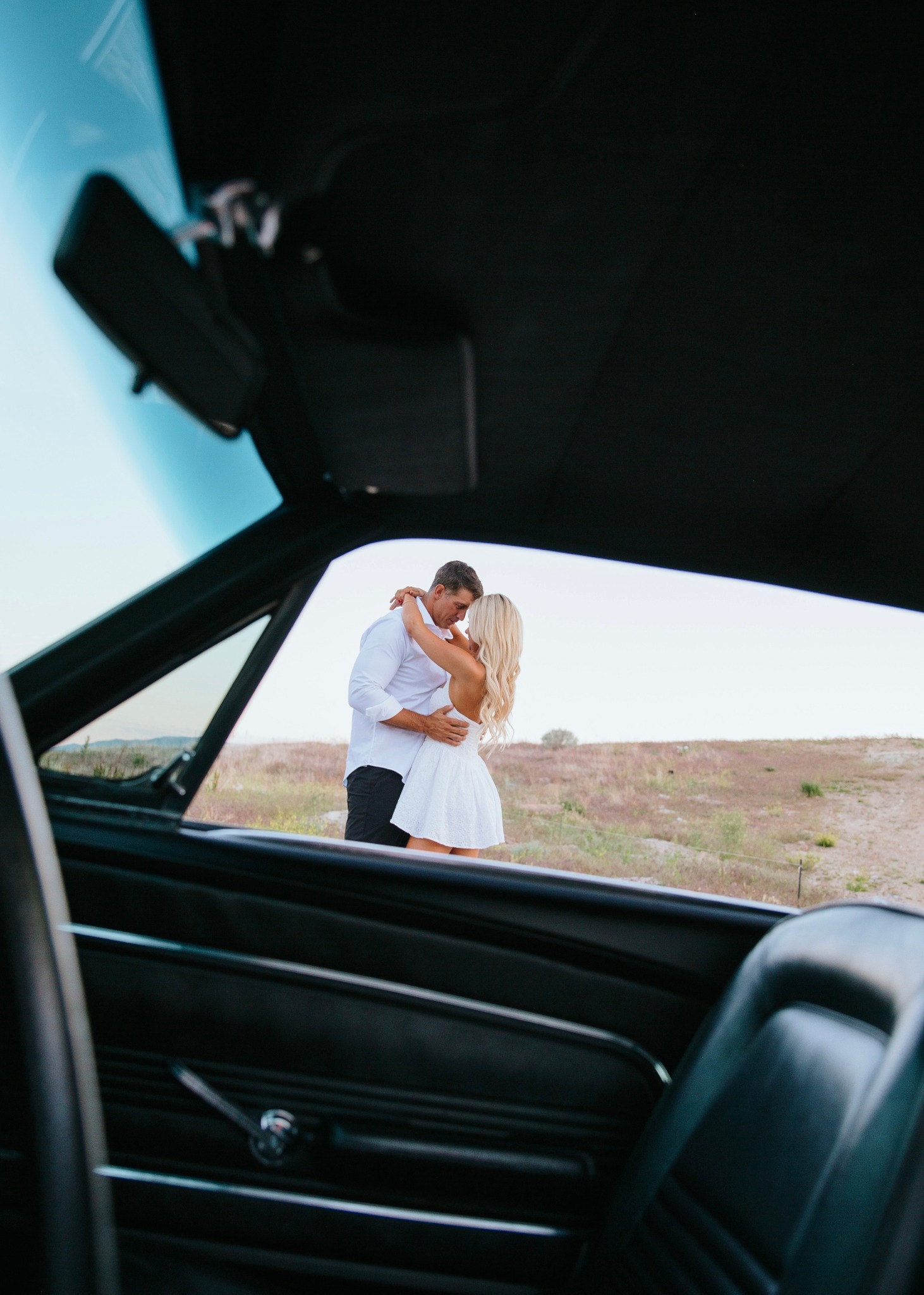Devin and Summer embracing through the open car door