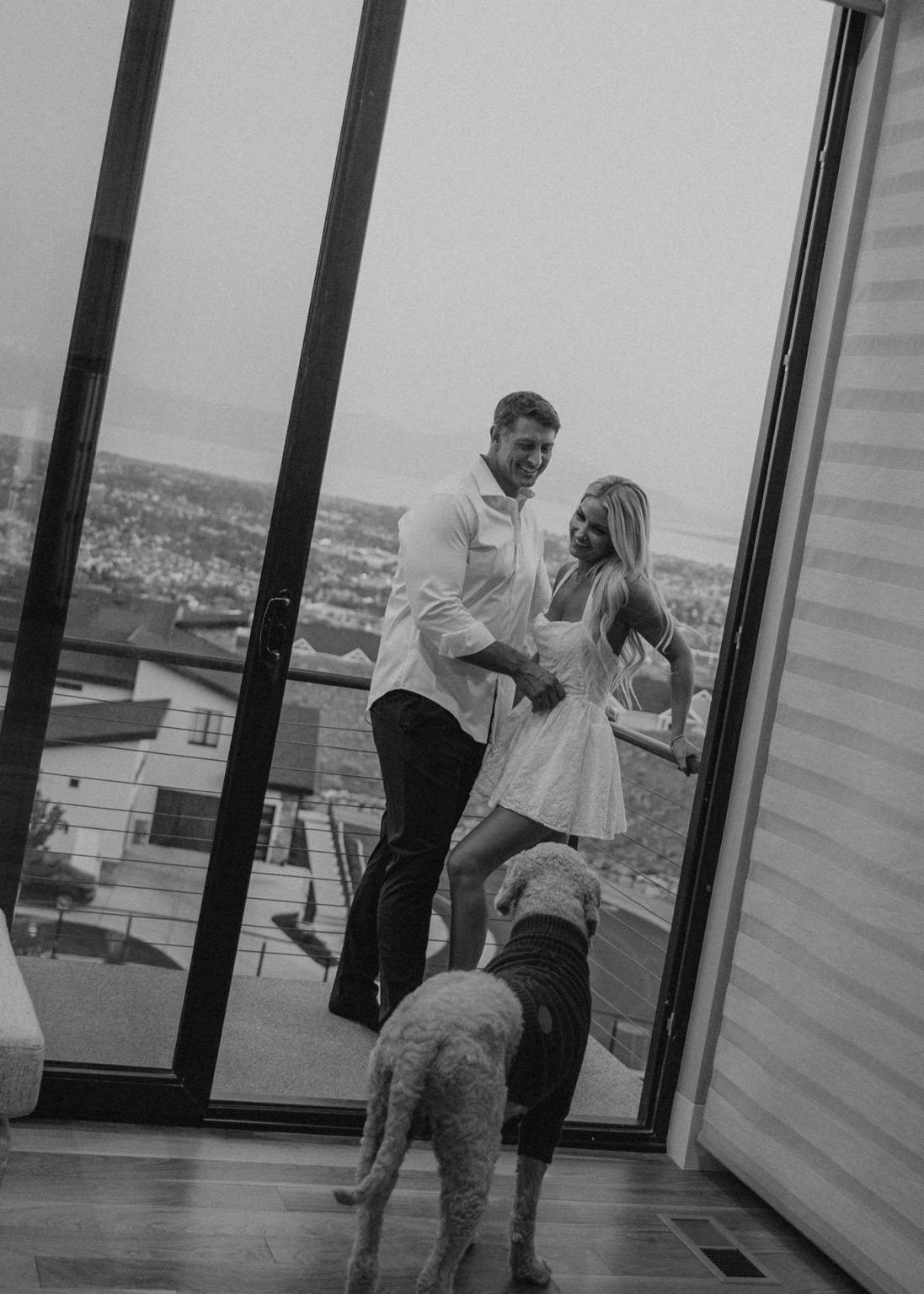 Devin and Summer laughing together on a balcony